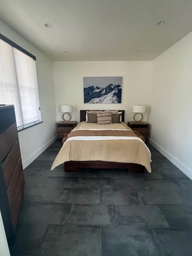 Queen bedroom with slate-tile floors and San Juan mountain artwork