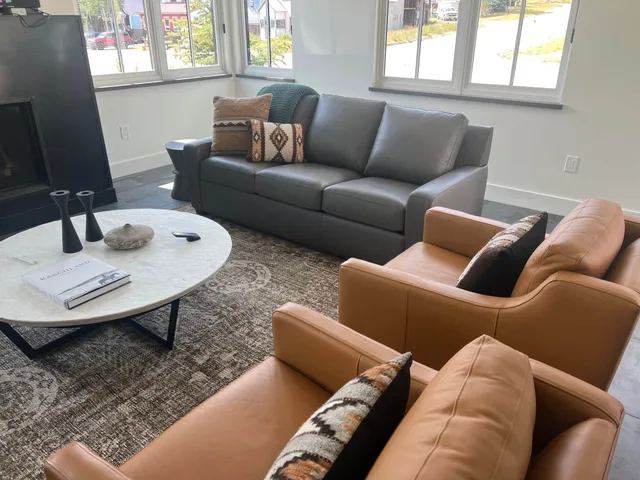 Comfortable living room with a grey sofa and tan leather armchairs